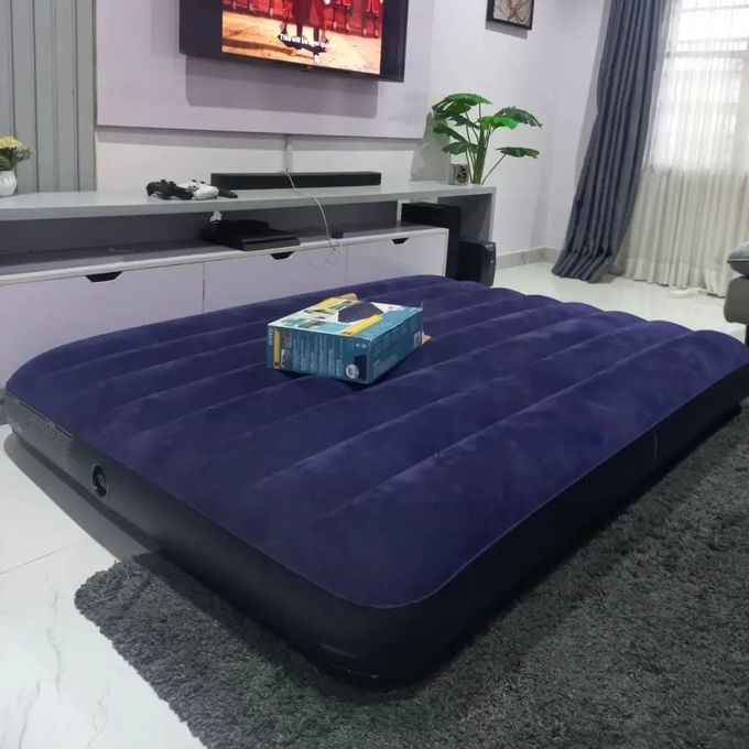 The original double-size inflatable bed fully set up in a modern living room